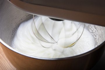 The process of whipping egg whites in a planetary mixer. Selecti