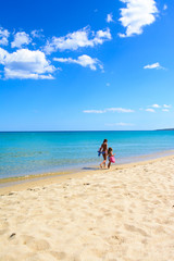 two sisters walking on the beach, tropical sea background