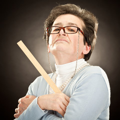 old strict teacher with glasses isolated on black