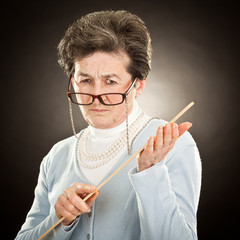 old strict teacher with glasses isolated on black