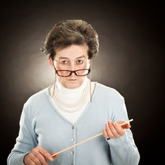 old strict teacher with glasses isolated on black