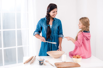 Happy mother and daughter baking