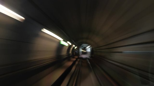 Timelapse shot of traveling through the underground tunnels, view from the cab. Train making stops and and arriving at outdoor station