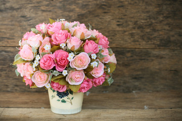 Plastic flowers with wooden background in vintage picture style, home interior equipment, Flowers set on wooden background. Hand made.