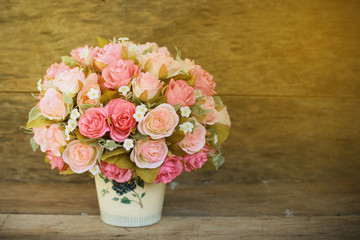 Plastic flowers with wooden background in vintage picture style, home interior equipment, Flowers set on wooden background. Hand made.