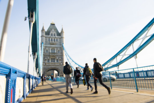 Out-of-focus image of unrecognisable pedestrians crossing Tower Bridge.