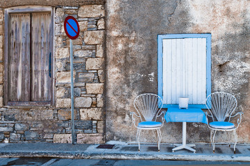 Chairs and table on a street in the greek town Kokkari © pavelr51
