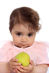 Child eating green apple. Studio Half Length Portrait , isolated on a white background