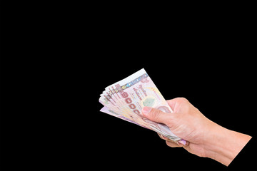 Hand with money isolated on a black background with clipping pat