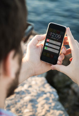 Man with sunglasses using  smartphone with notifications near th