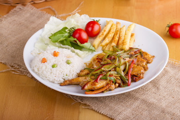 original fajita sizzling smoking Chicken breast with vegetables and sauce decorated with basil leaves
