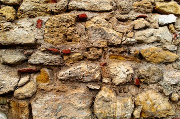 Old and rough stone wall background. Wallpaper.