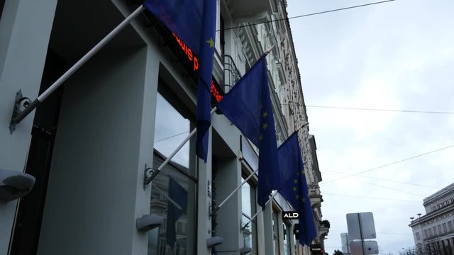 EU flags in front of builing with ticker