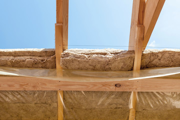 New residential construction home framing beams with insulation layer and protection film