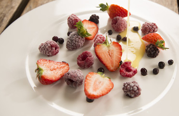 Delectable frozen summer berries with warm white chocolate sauce 
