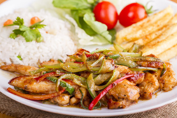 original fajita sizzling smoking Chicken breast with vegetables and sauce decorated with basil leaves