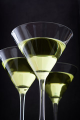 Green apple cocktail on black stone background
