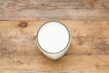 Glass of milk on wooden table