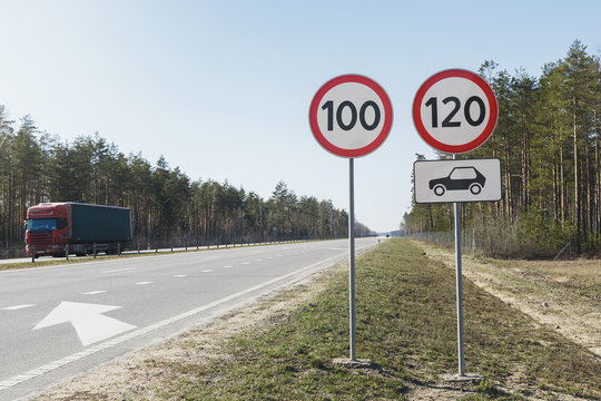 Car passing speed limit sign 100 and 120