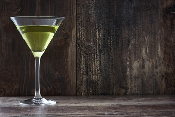 Green apple cocktail on wood background
