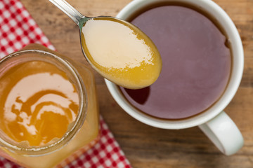 Cup of Tea with honey on the wooden background.
