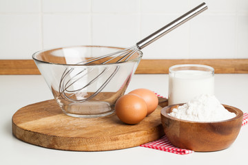Ingredients and tools to make a cake, flour, eggs on kitchen top