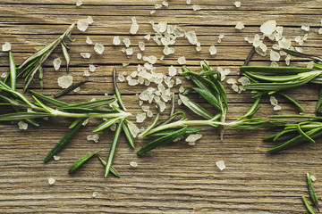 Rosemary and sea salt on wooden background top view