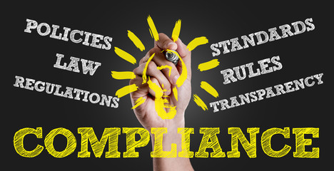 Hand writing the text: Compliance