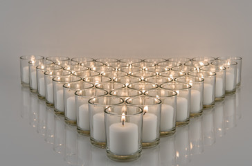 White Votive Candlelight on Reflective Surface