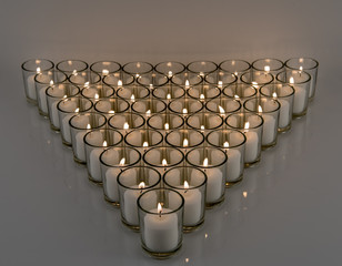 White Votive Candlelight on Reflective Surface