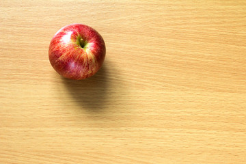 Red apple in basket on wood background