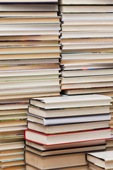 books are stacked against a wall