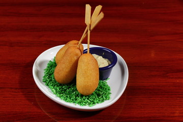 Sausage on a skewer in a corn dough deep fried, homemade corn dogs