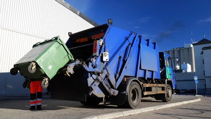 Garbage transport car loading itself in port. Landfill site, ecology, environmental damage,...
