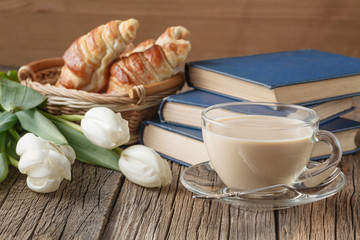 Fresh coffee with cookie and book.
