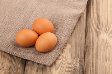 eggs with burlap material and wood background