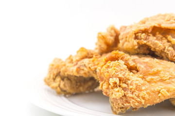 Fried chicken in white plate on white table, on isolate