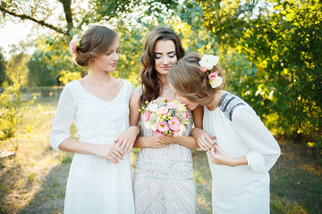 Beautiful bridesmaids. Bridesmaids sniffing bouquet