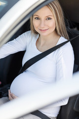 Pregnant woman driving her car