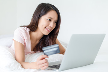 Woman using laptop computer for online shopping
