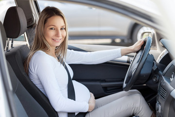 Pregnant woman driving her car