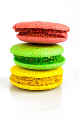Sweet beautiful colored French almond biscuits on a white background close-up