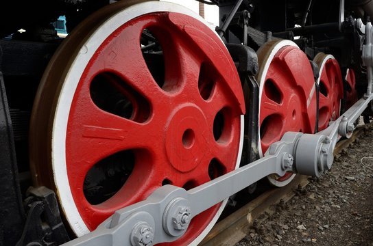 The massive wheels of the locomotive.