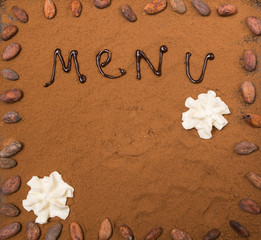 Menu frame leaflet with cocoa powder and whipped cream toned selective focus