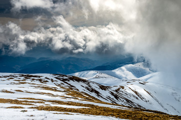 Winter landscape in the mountains. Mountain ridges covered by snow in  winter in Europe.