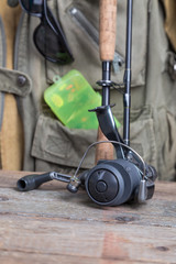 fishing tackles with fishing vest and wooden