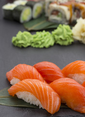 Japanese cuisine. Salmon sushi nigiri over black background