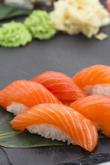 Japanese cuisine. Salmon sushi nigiri over black background