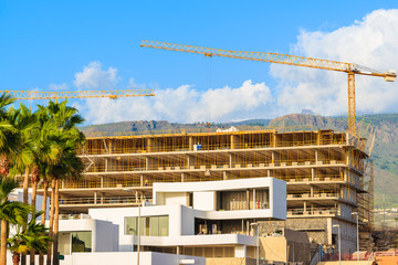 Hotel buildings under construction in Costa Adeje town on tropical Tenerife island, Spain - obrazy, fototapety, plakaty