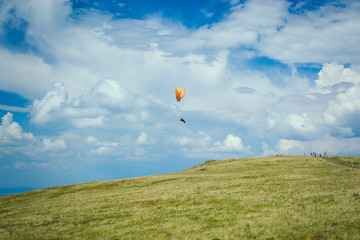 Paraglider, paragliding in the mountains, adrenalin sports